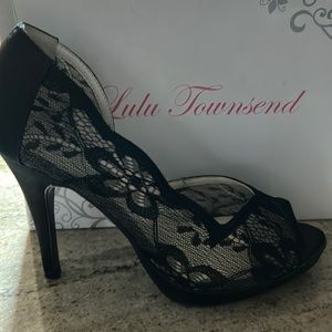 Elegant lace and “leather” heels. Appropriately 3 1/2 inch heel. Never worn.